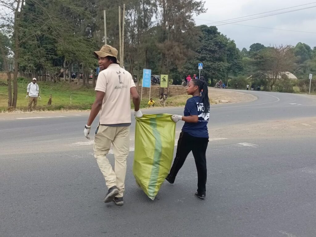 Two people carrying a collection sack